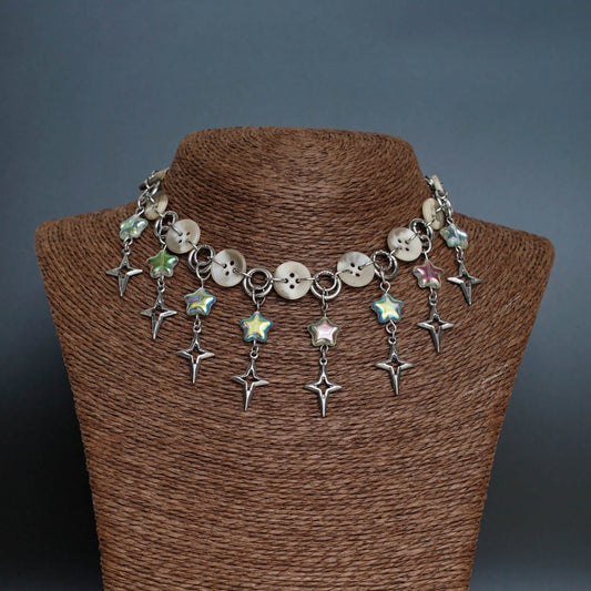 Necklace with star-shaped charms on a brown mannequin against a dark background